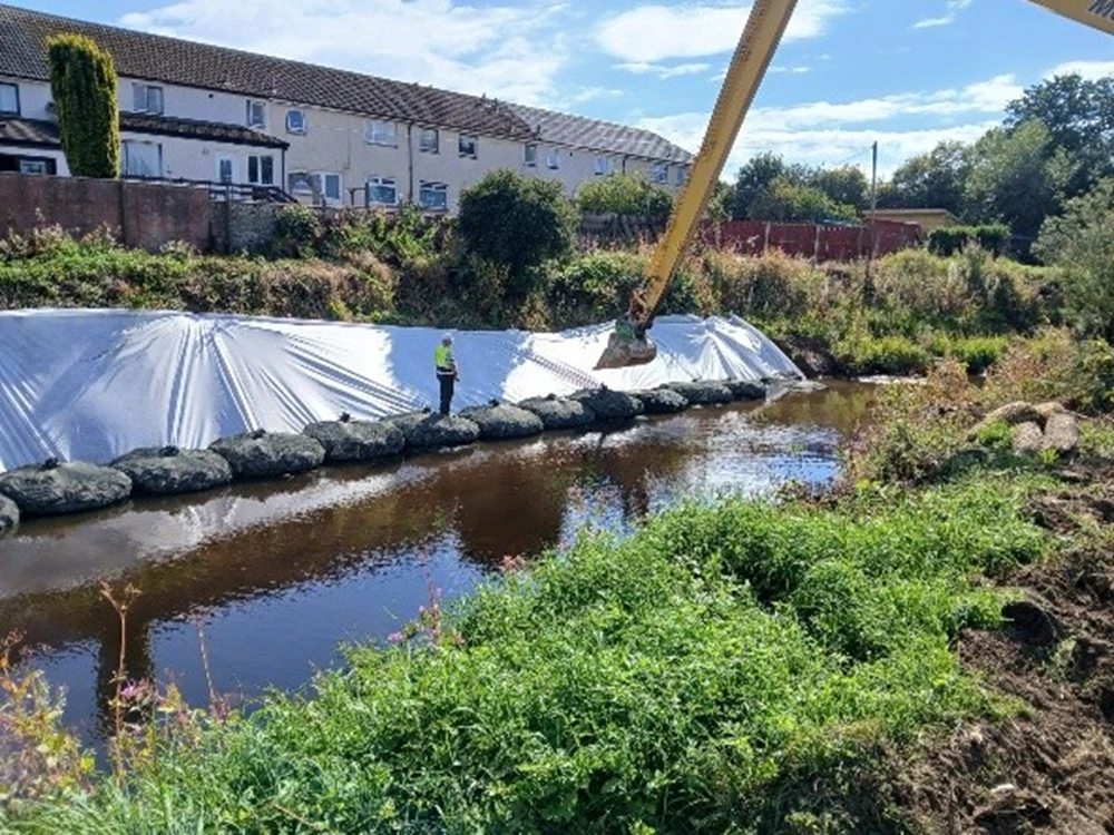 Rock bags being installed along the riverbank at Annick Water
